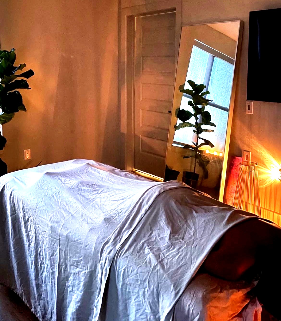 Cozy wellness room with mirror and plants at Y.S Health and Wellness